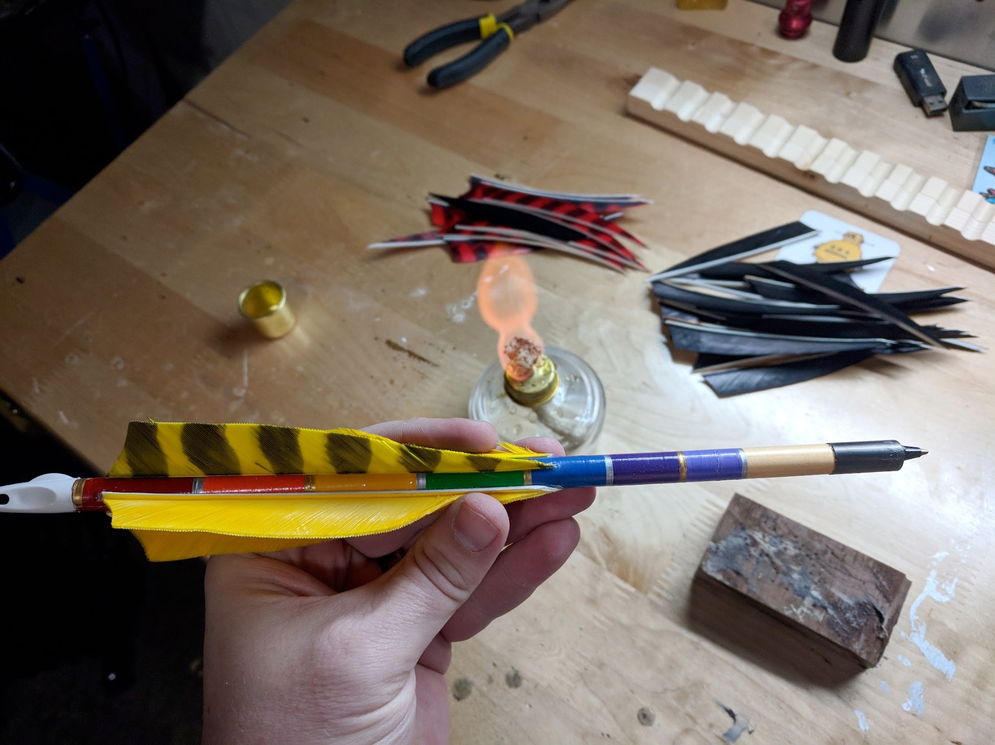 Rainbow crested arrow held in hand at the workshop