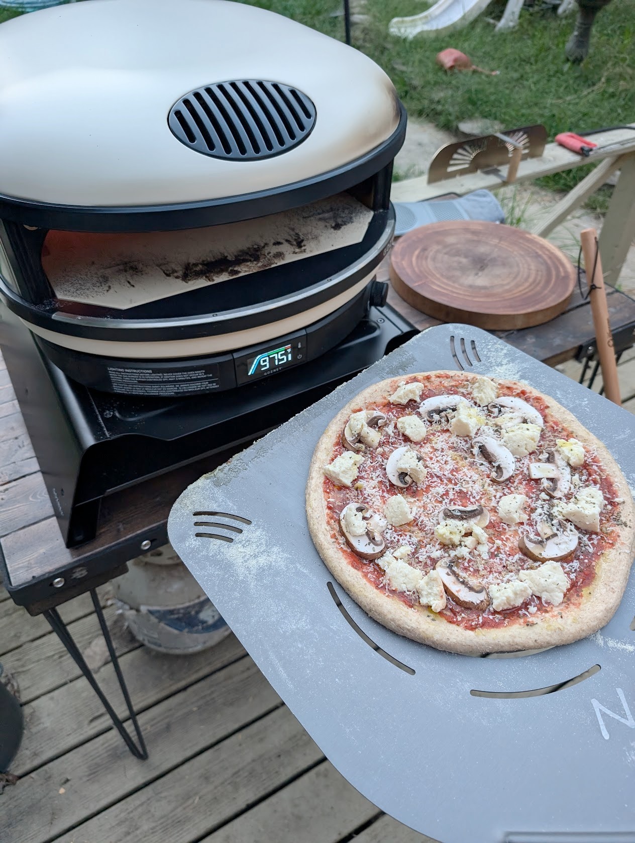 Mushroom and mozzarella pizza ready for the outdoor pizza oven at 975°F