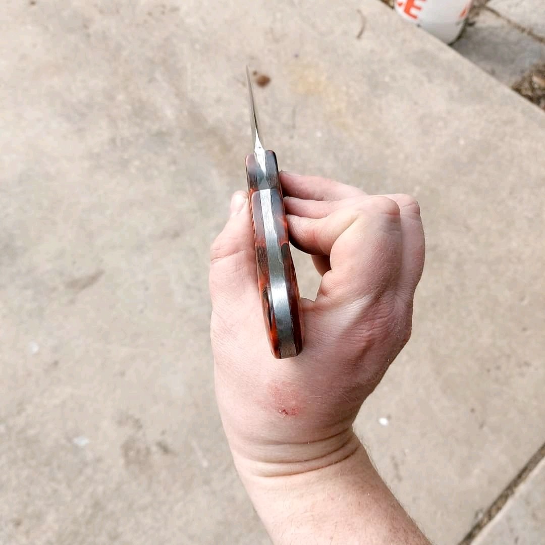 Spine view of a hand-forged knife showing handle fitment