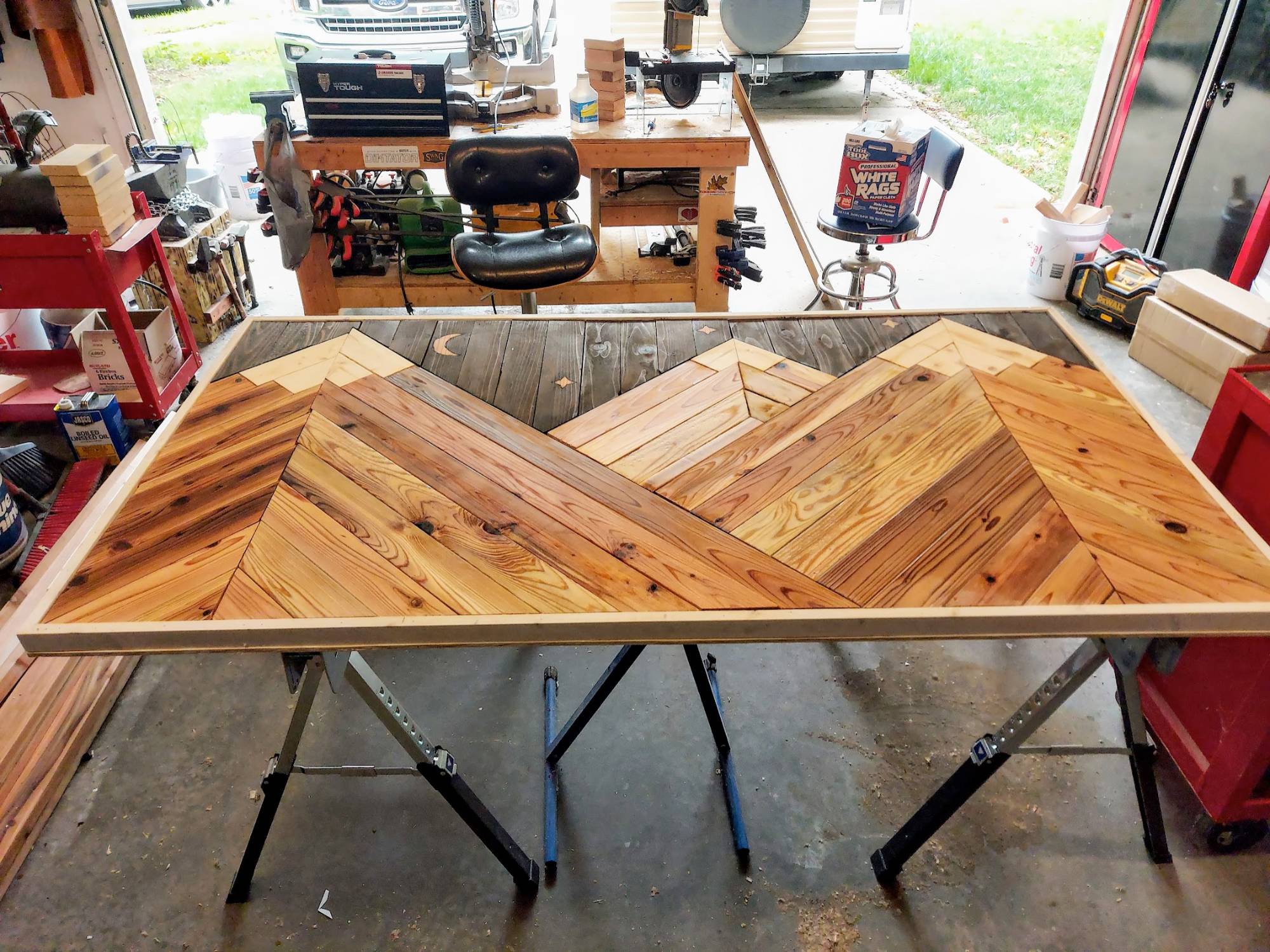 Reclaimed wood mountain wall art with moon and stars — in progress on the workbench