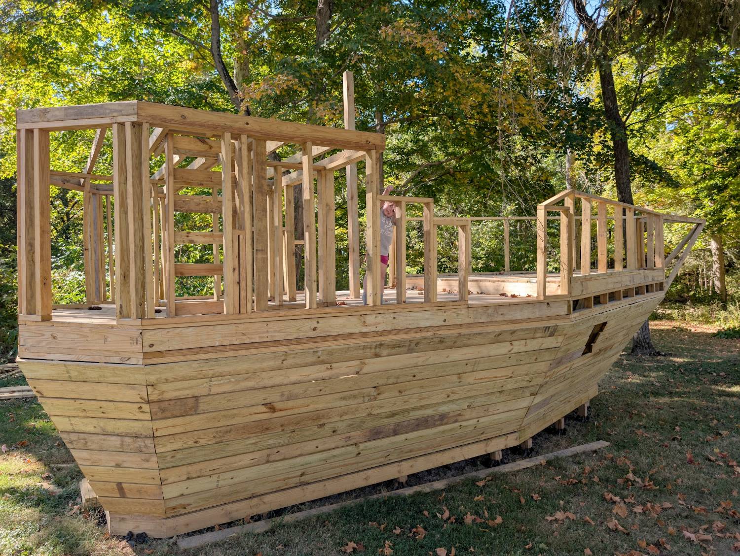 Full-size pirate ship playhouse — framing stage with cabin and bow