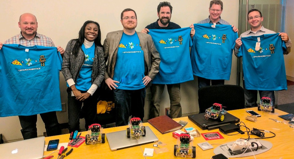 Spark Robotics team with custom-built robots and team shirts